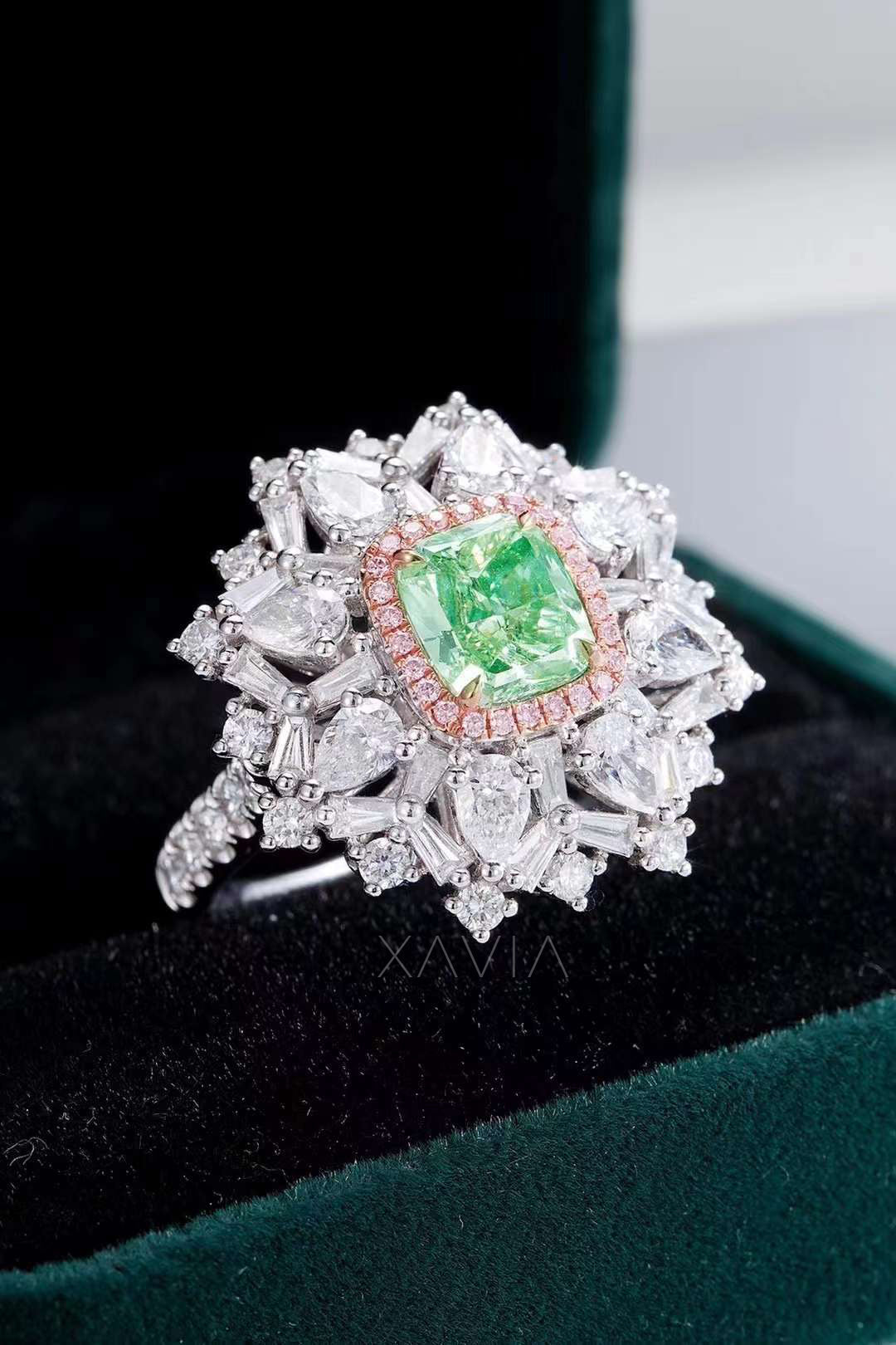 cushion cut green diamond cocktail ring with pavé pink halo and white diamond starburst displayed in velvet jewelry box