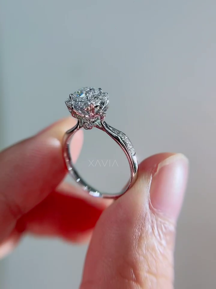 Close-up gallery view showing floral basket structure beneath round halo diamond setting with pavé-set engagement band