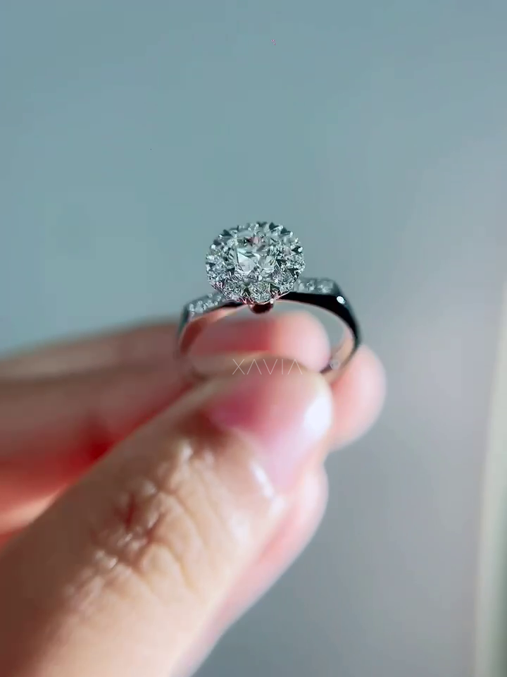 Under-gallery view of engagement ring revealing hidden ruby accent stone beneath floral diamond halo crown