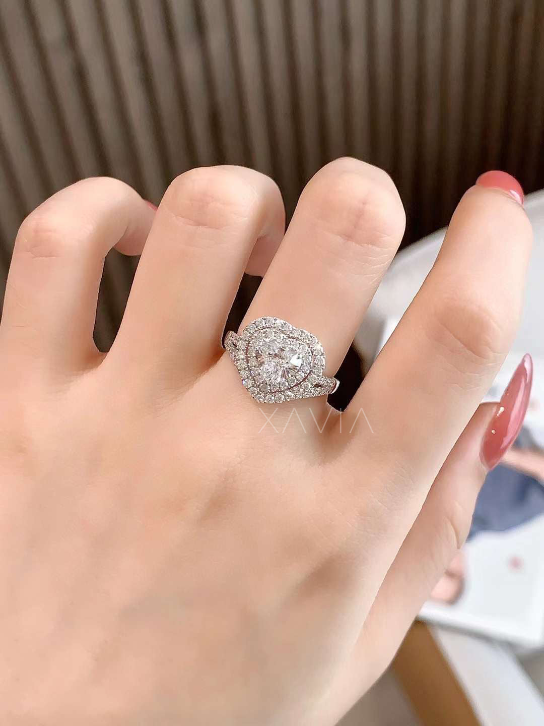 model hand wearing heart cut lab diamond double halo engagement ring with pavé split shank band