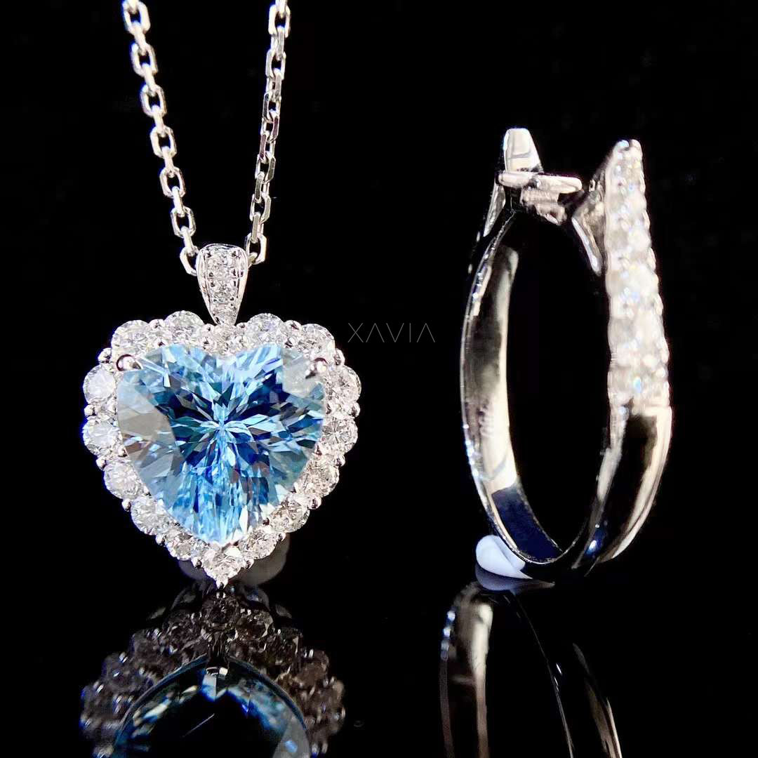 Side profile of heart cut blue gemstone engagement ring showing elevated halo setting and pavé diamond band with brilliant round diamonds