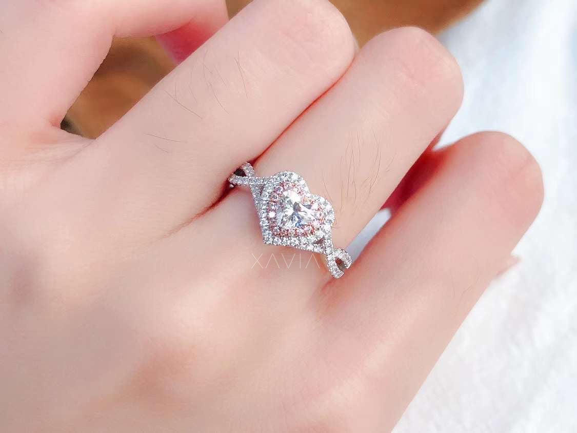 close-up of heart cut lab diamond engagement ring with double halo and pavé infinity band on model’s hand