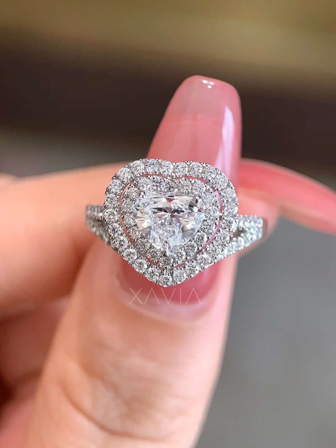 close-up of heart cut lab diamond engagement ring with double halo and pavé split shank in white gold