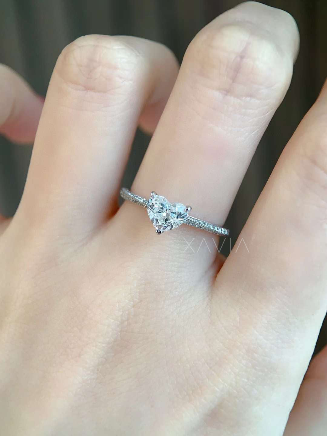 heart cut diamond engagement ring with pavé set band elegantly worn on hand, crafted in white gold