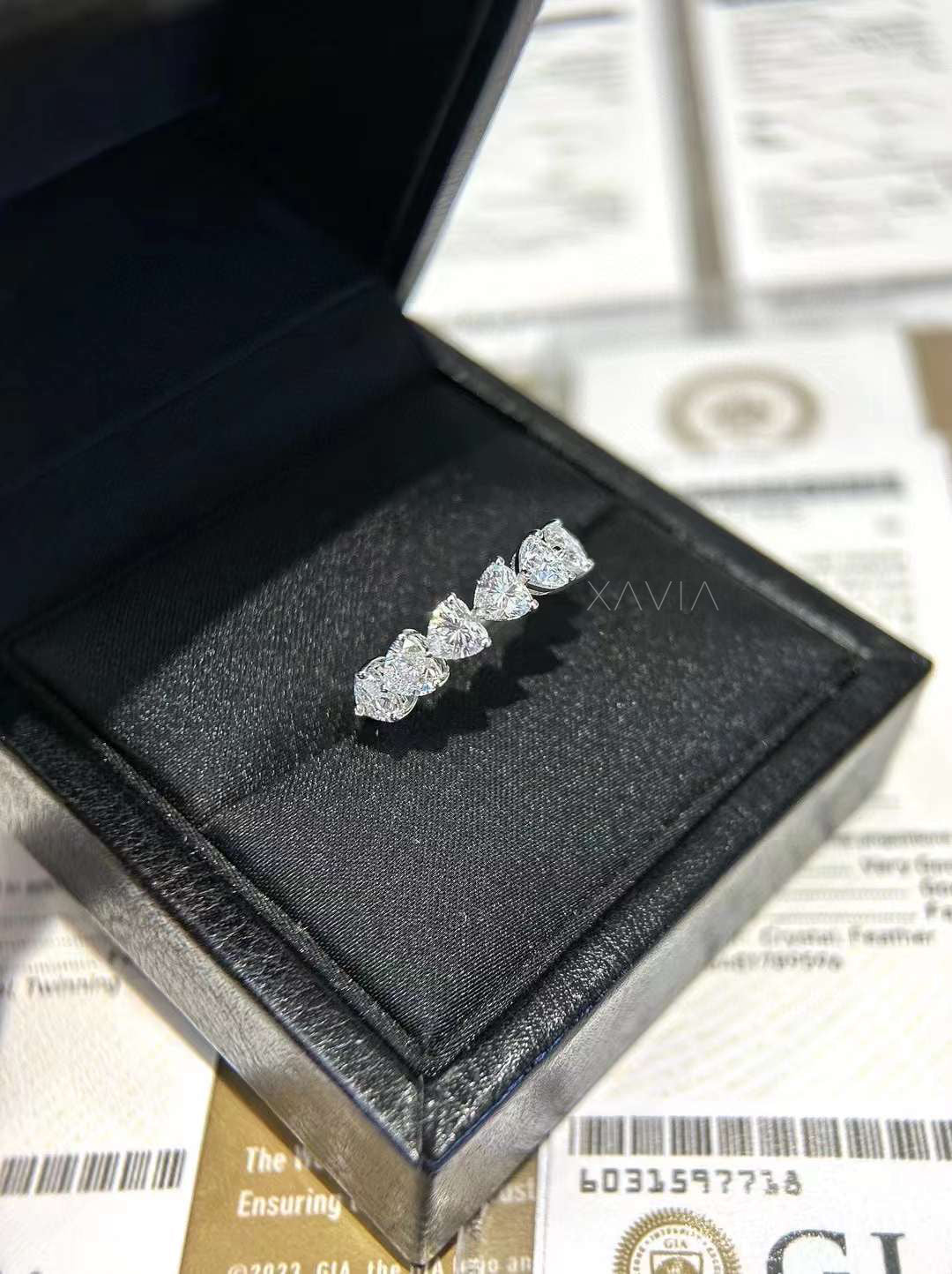 Heart diamond half band in platinum displayed in luxury black box with GIA paperwork background