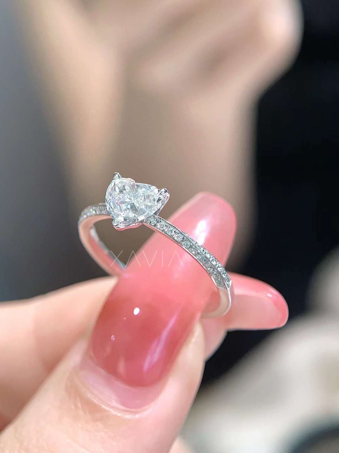 side profile showing raised prong setting of heart shaped lab-grown diamond engagement ring with pavé accented band