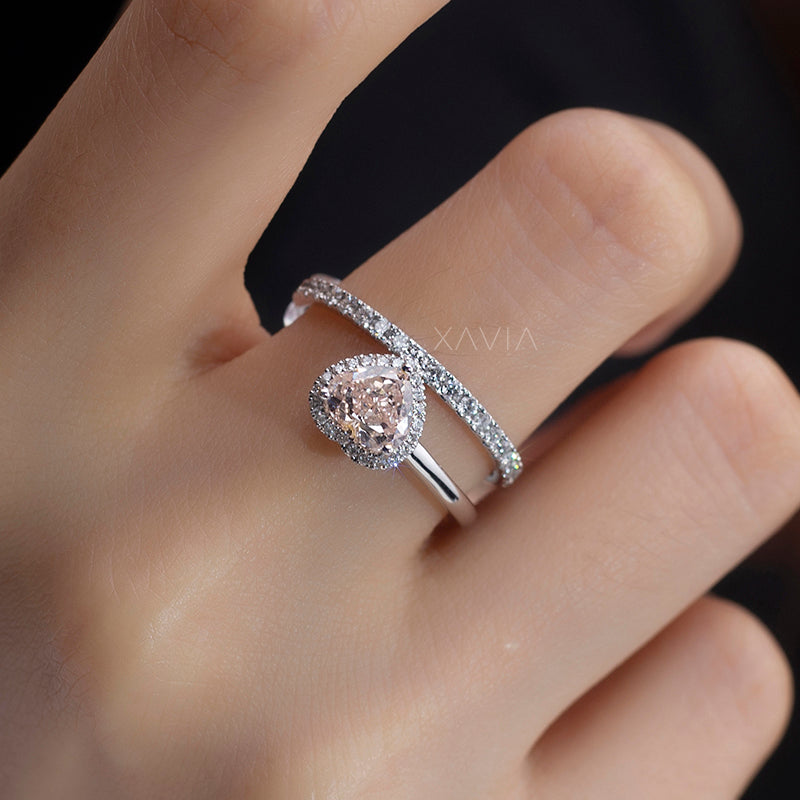 side angled view of heart shaped lab diamond engagement ring with halo and pavé eternity band
