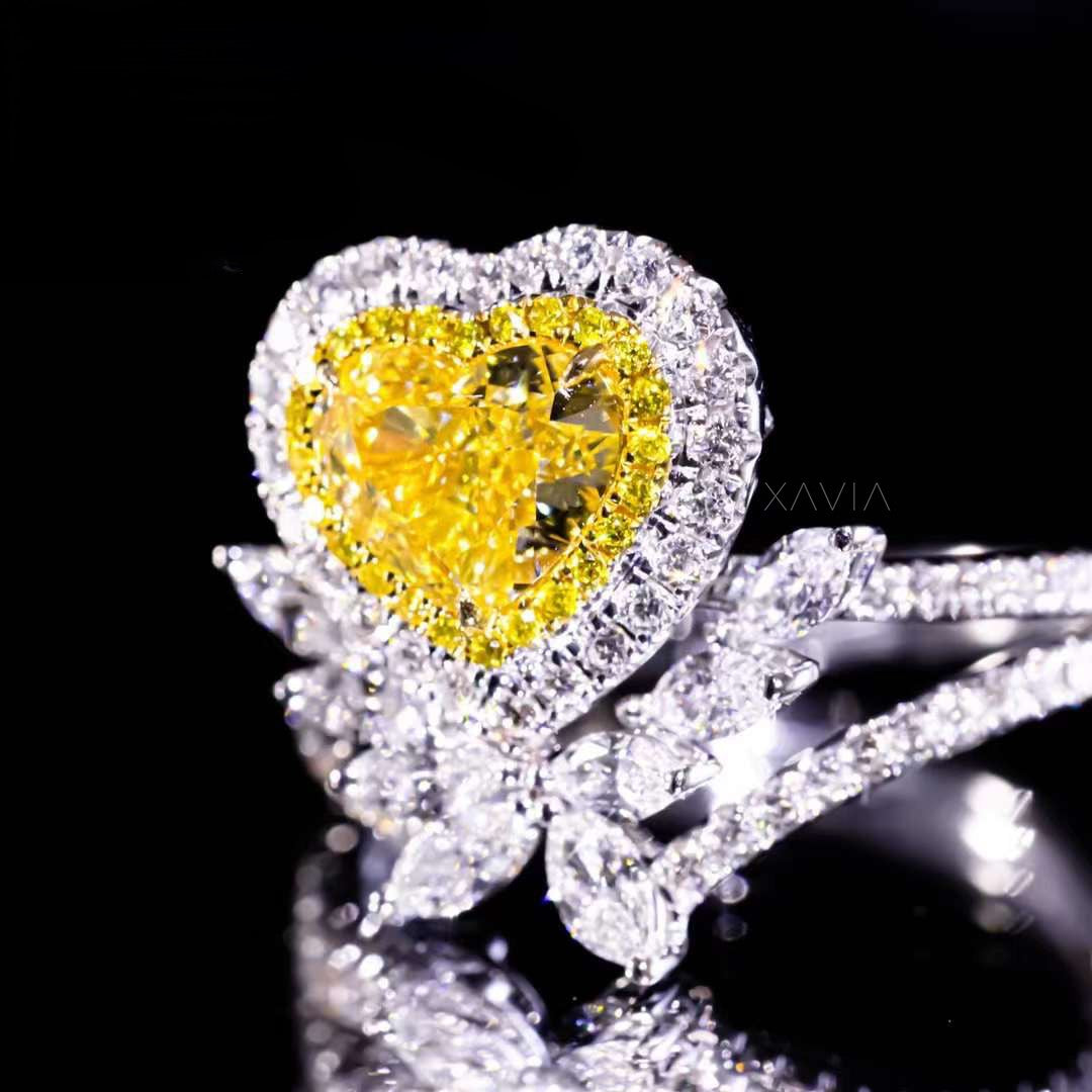 side profile view of heart-shaped fancy yellow diamond engagement ring with double halo and marquise white diamonds