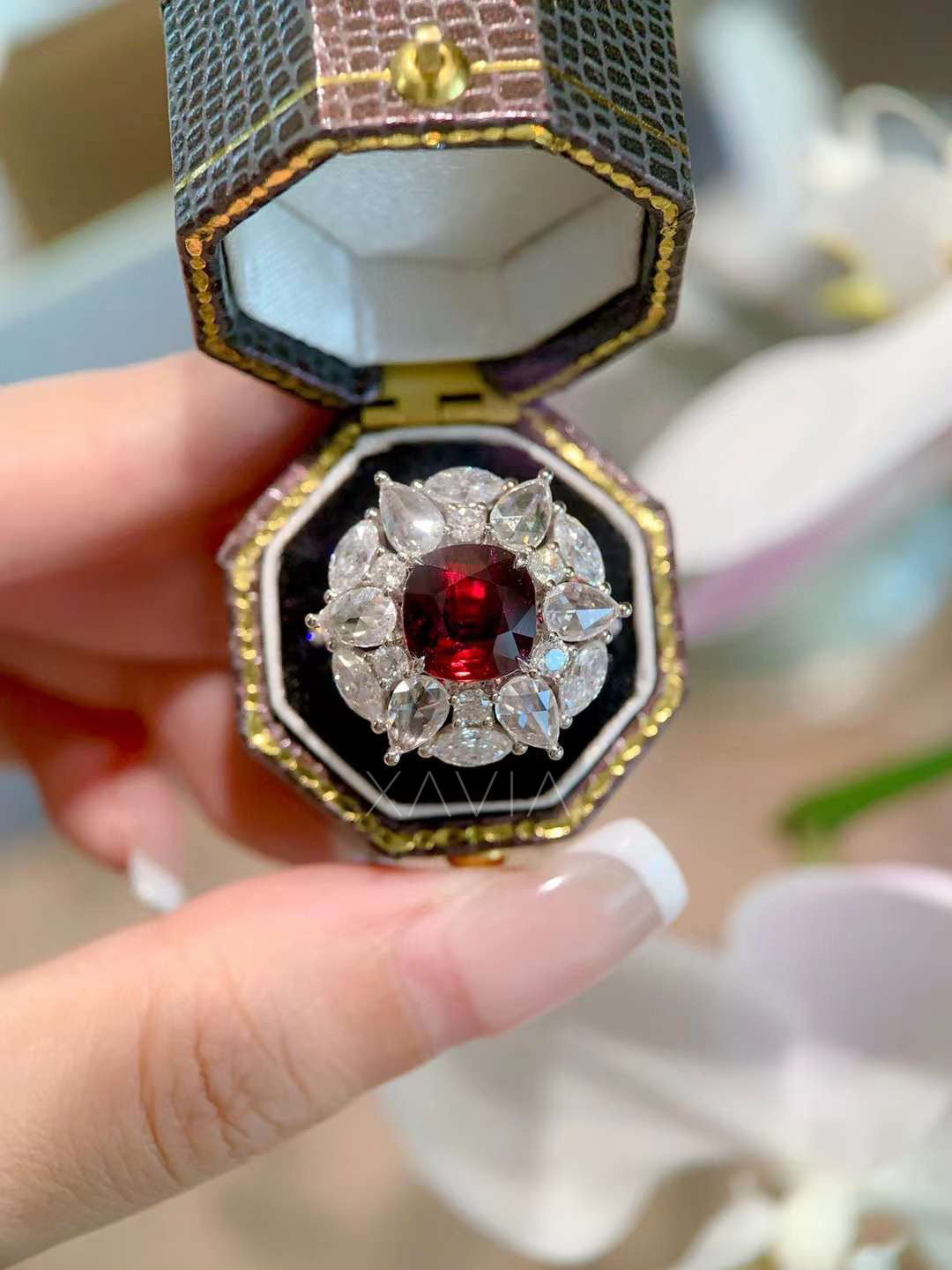 close-up detail of Astrielle ruby and diamond floral halo cocktail ring with cushion ruby and brilliant lab diamonds