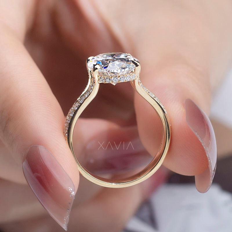 Rear view of oval cut lab diamond engagement ring showing hidden halo beneath center diamond, cathedral shoulders and pavé split shank design in polished yellow gold