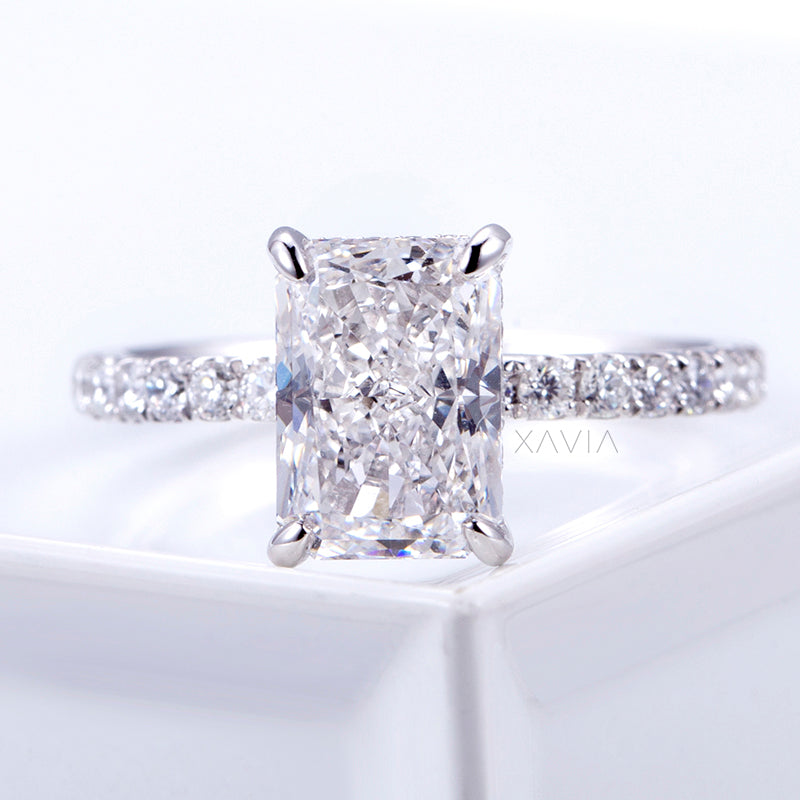 Illumé radiant cut lab grown diamond engagement ring with four prong setting and pavé band photographed in high polish white gold