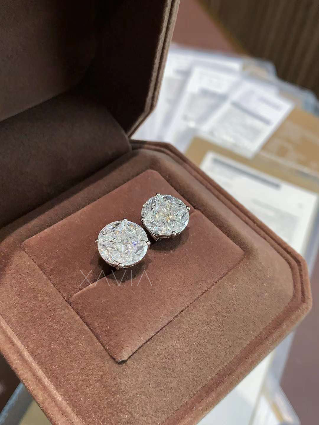 Close-up of illusion round diamond earrings in jewelry case