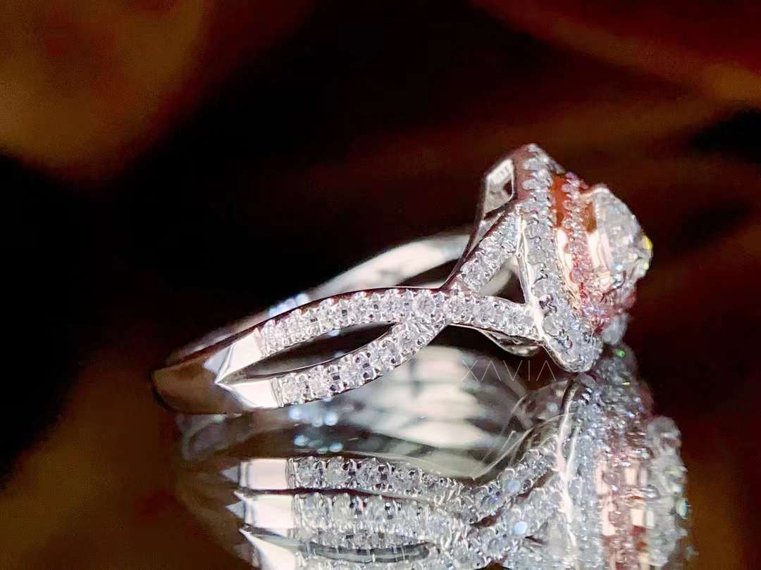 angled side profile of heart cut lab diamond ring with infinity-style pavé band and double halo design