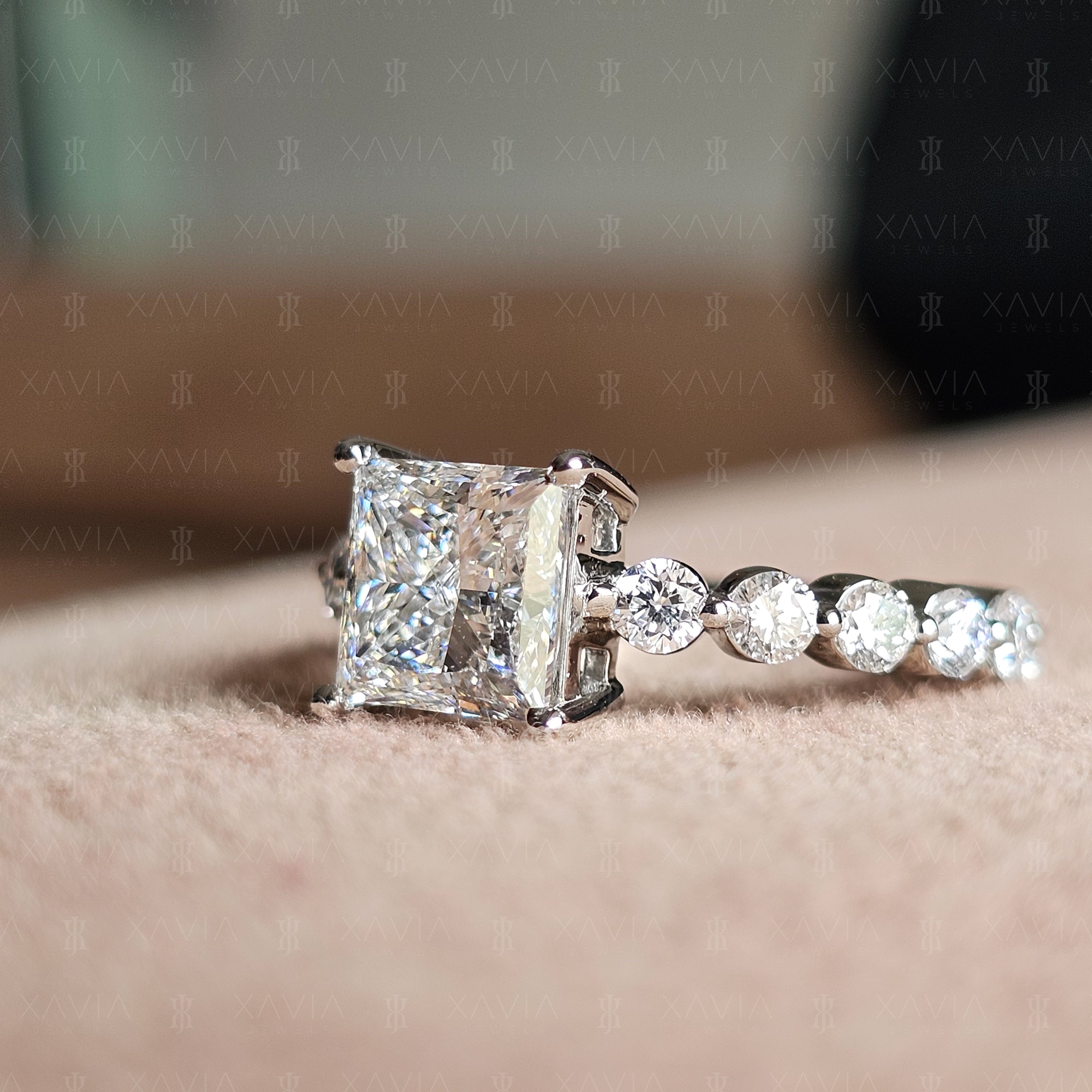 Low side angle of princess cut lab-grown diamond ring highlighting geometric solitaire profile and shimmering round diamond eternity band