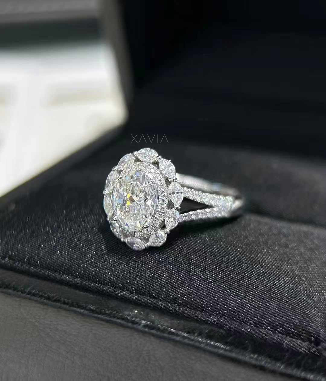 top angle of Lunessence oval cut lab diamond engagement ring with floral marquise halo cluster and pavé band, crafted in platinum