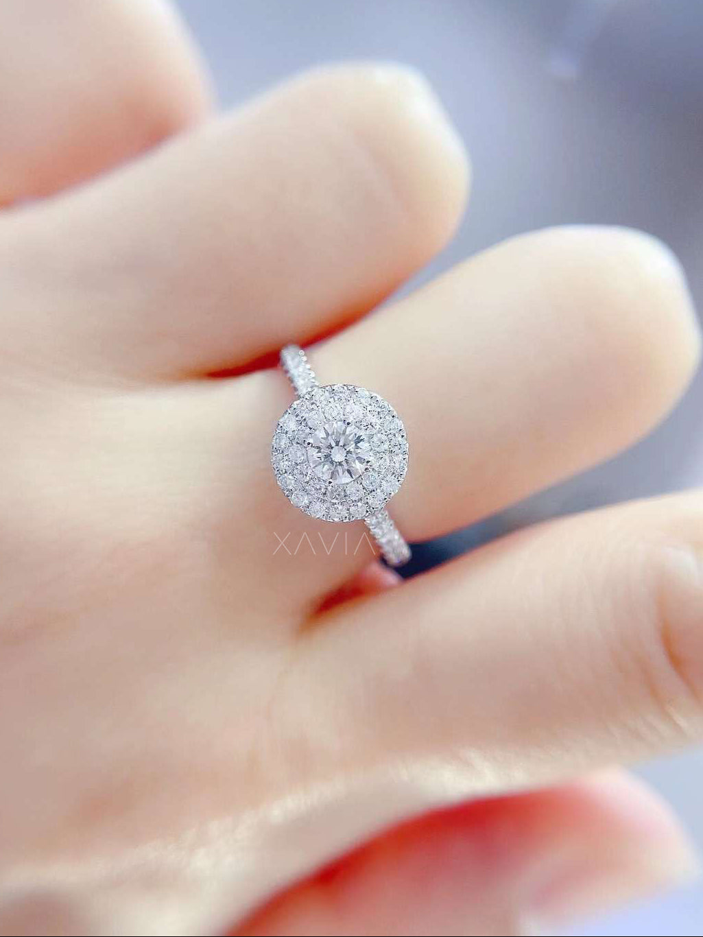 Luxury round cut lab diamond halo engagement ring photographed on hand showing sparkle, symmetry, and elegant white gold finish