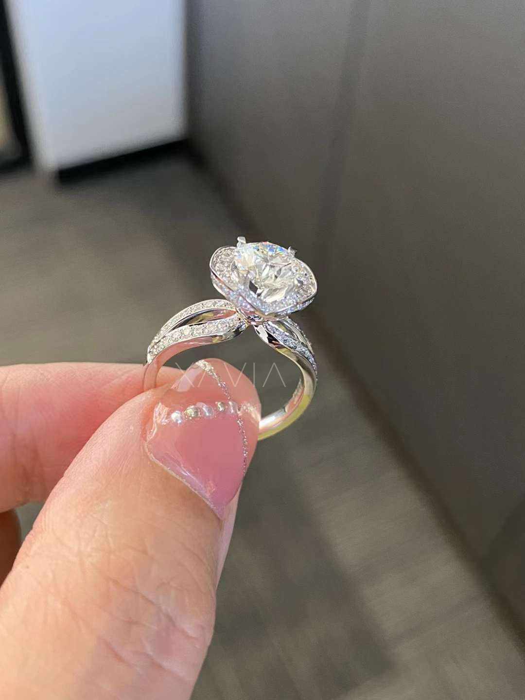 top angle of round brilliant cut halo diamond engagement ring with pavé split shank in white gold