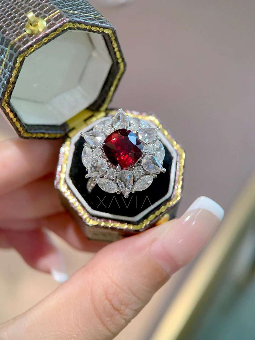top angled luxury view of Astrielle ruby floral halo ring with cushion ruby and surrounding pear and marquise lab diamonds