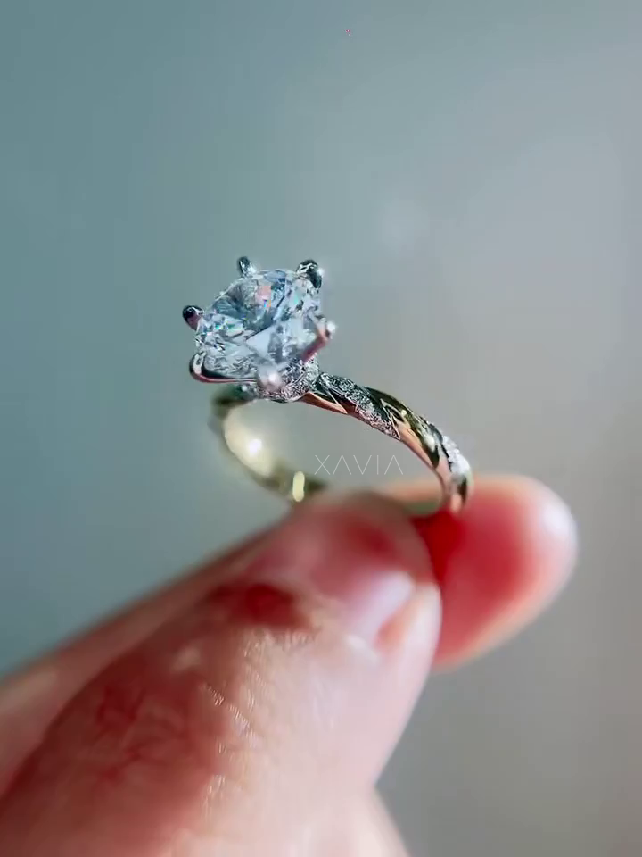 luxury round brilliant diamond solitaire engagement ring with twisted pavé band and elevated cathedral style prongs photographed in soft focus