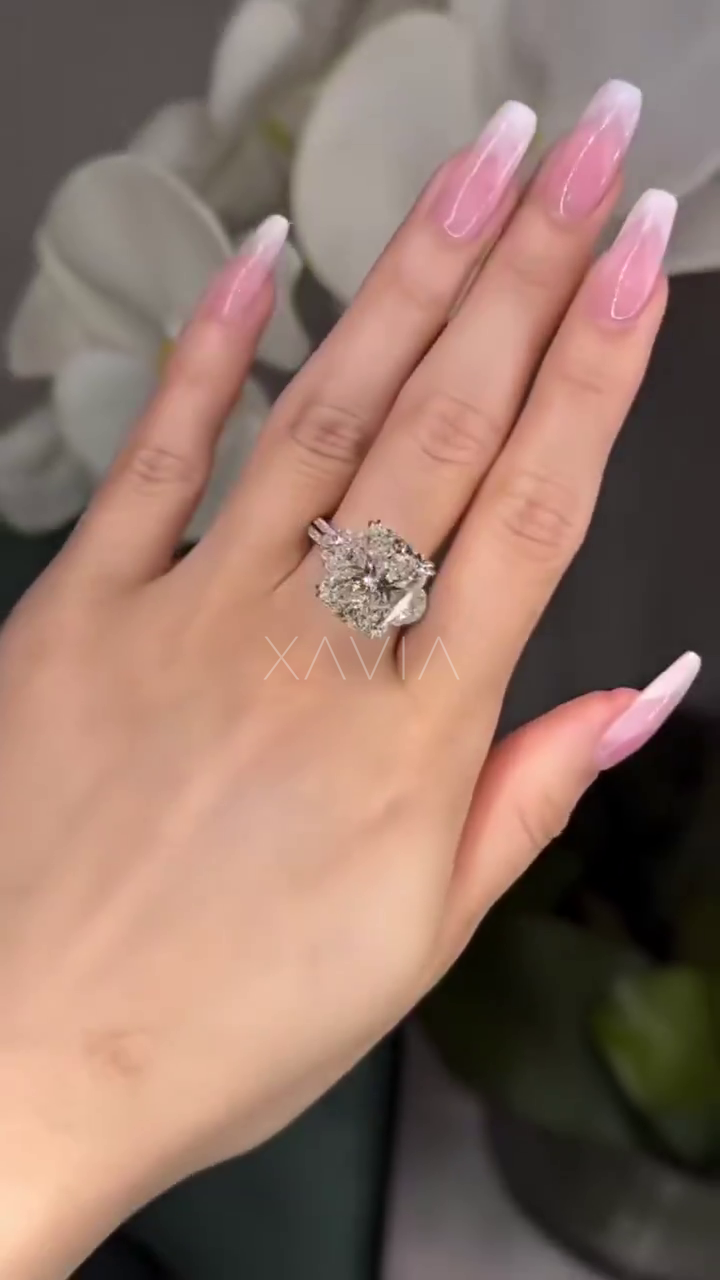 luxury cushion cut lab diamond ring with trapezoid side stones and pavé band in platinum worn on hand