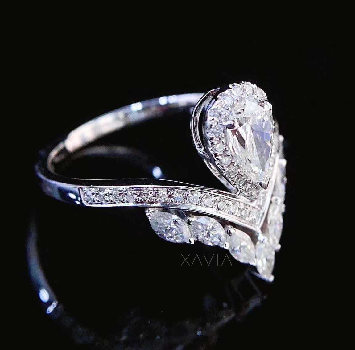 Open bypass diamond ring with marquise cut lab diamonds arranged in leaf inspired pattern around pear halo center