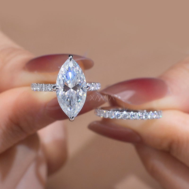 Diamond ring held between fingers with a blurred background