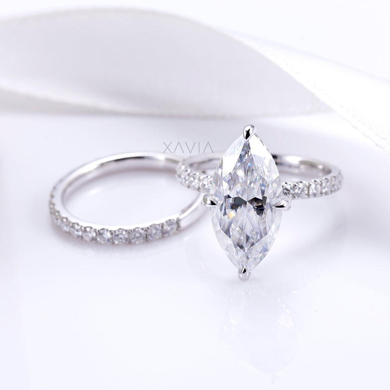 Studio angled image of marquise cut lab grown diamond engagement ring highlighting symmetry, clarity, and fine pavé detailing