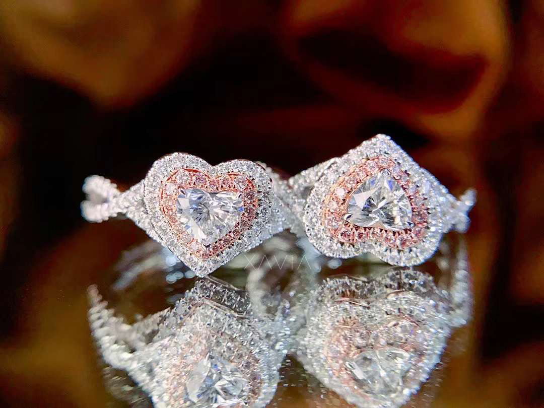 pair of matching heart cut lab diamond rings with rose gold inner halo and pavé infinity bands
