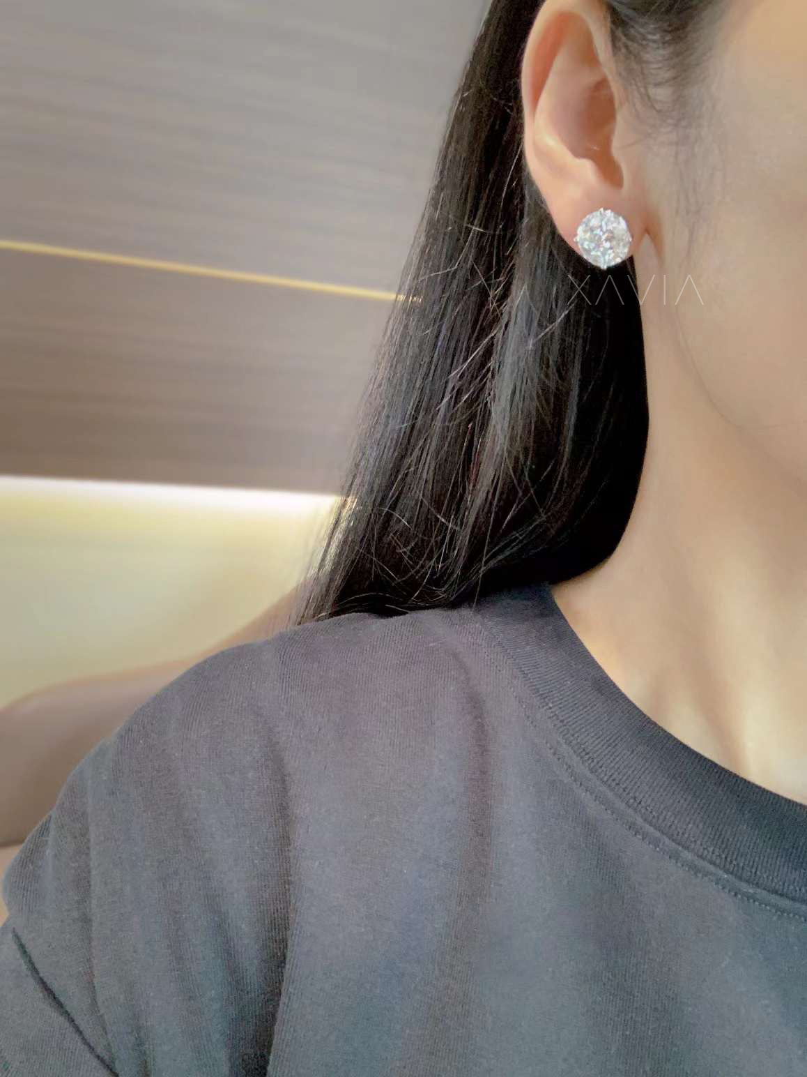 Model wearing round illusion diamond studs for everyday look