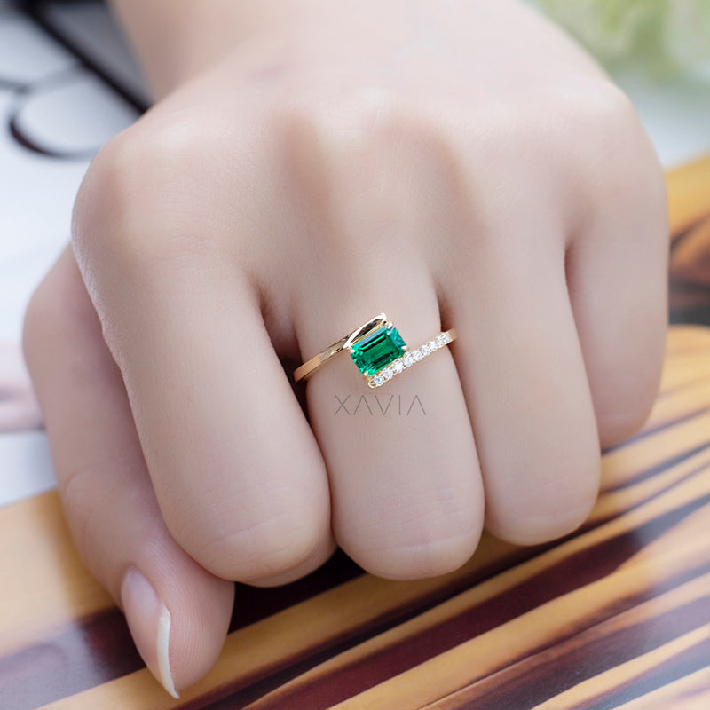 Lifestyle image of emerald cut lab diamond open band ring displaying minimal modern design and refined pavé sparkle