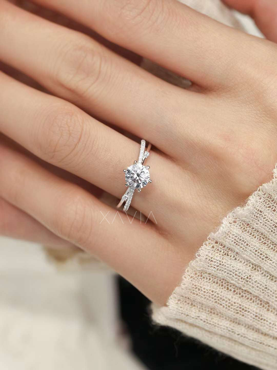 elegant top angle view of solitaire round lab diamond engagement ring with sparkling pavé split band on finger