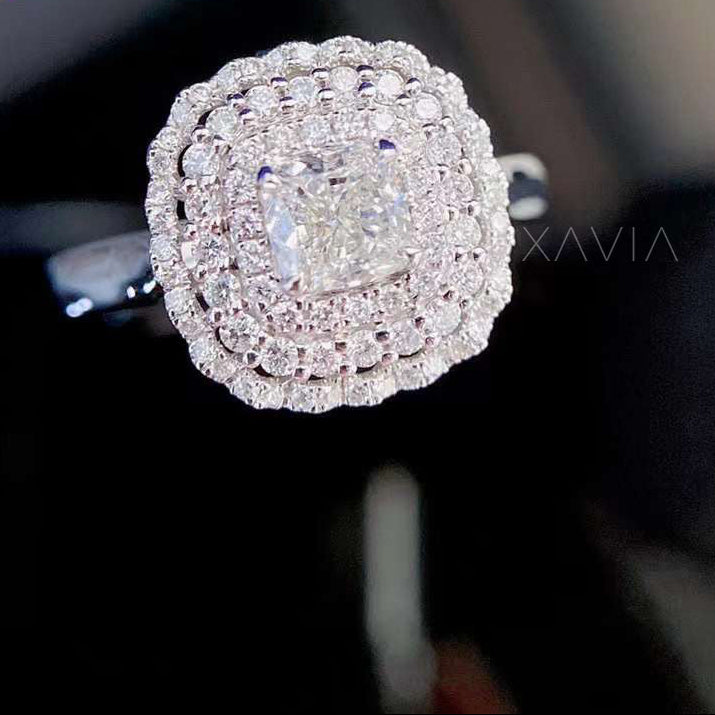 Noctyra cushion cut lab grown diamond engagement ring worn on hand, featuring a double halo of pavé diamonds and sculpted split shank brilliance.