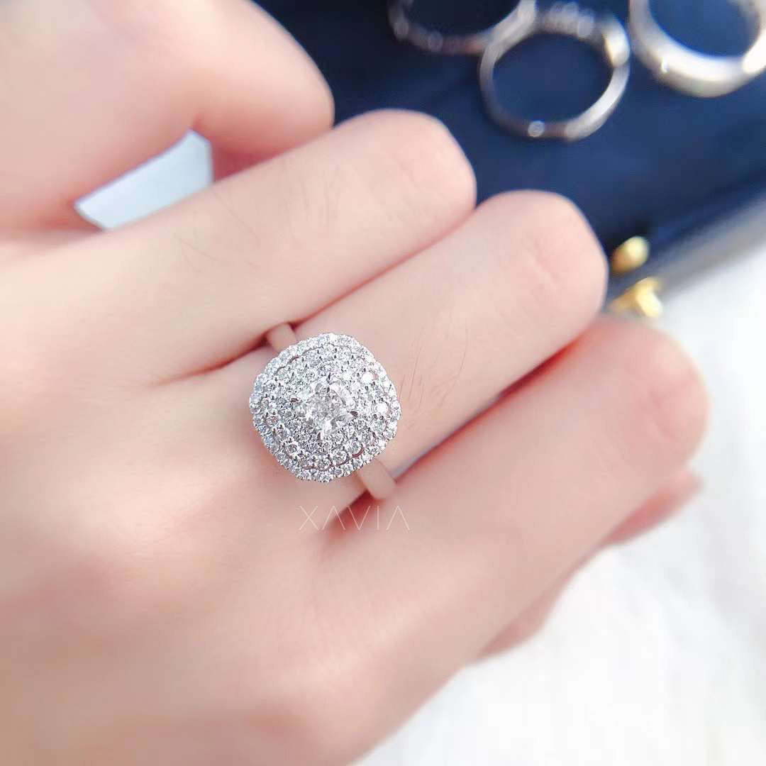 Angled close-up of Noctyra cushion cut diamond ring highlighting pavé double halo depth, center brilliance, and luxury craftsmanship.