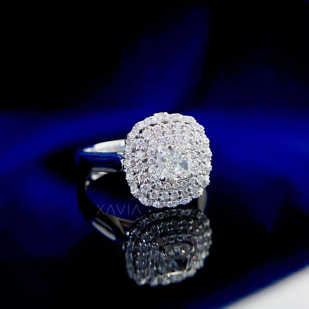 Noctyra cushion cut double halo lab diamond ring photographed on reflective surface emphasizing brilliance, polish, and heirloom presence.