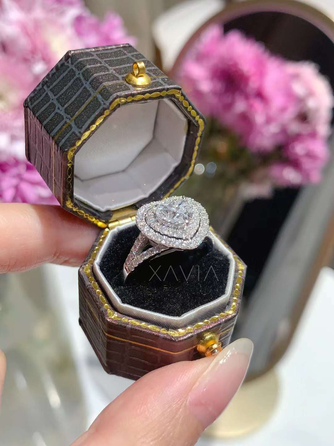 white gold heart cut lab diamond halo ring shown in octagon shaped luxury jewelry box