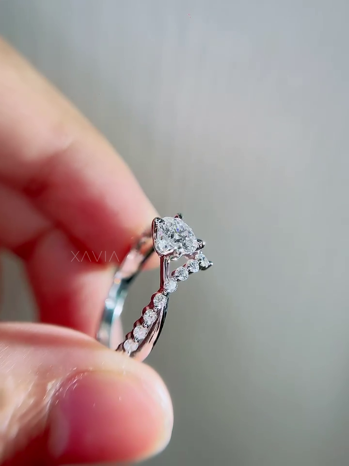 Opposite side view of round lab grown diamond engagement ring highlighting floral pavé accents, secure prong structure and elegant twisted pavé band design