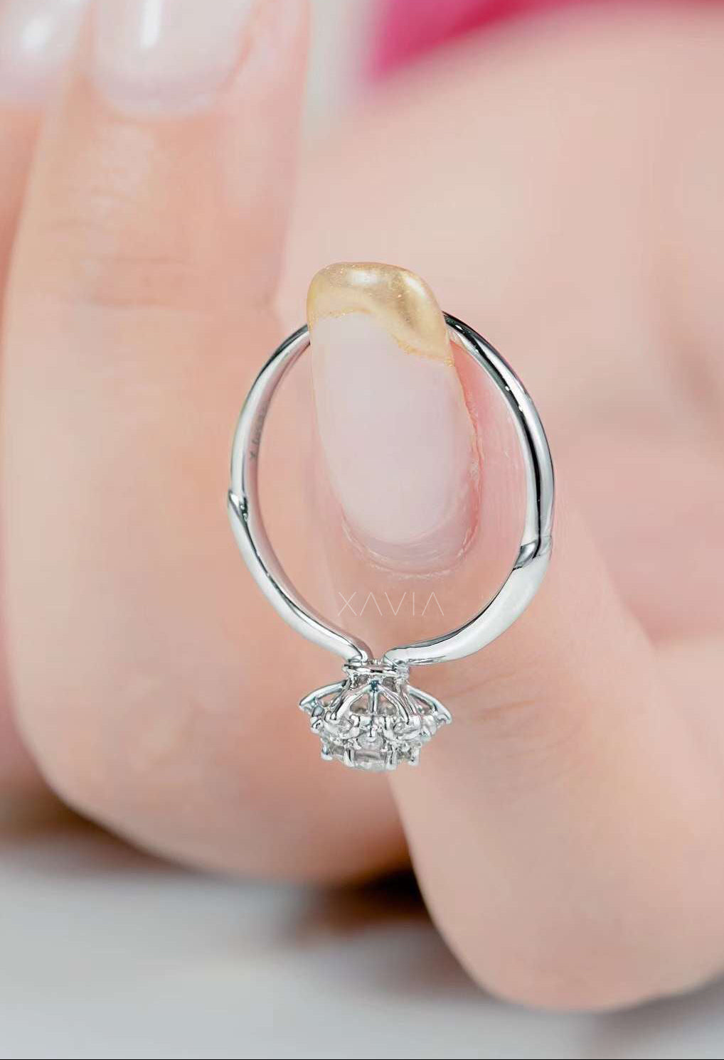 Top angle view of round brilliant lab diamond engagement ring with clustered floral halo and symmetrical prong setting