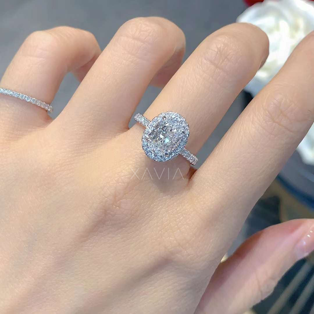 close-up view of oval halo diamond engagement ring in white gold