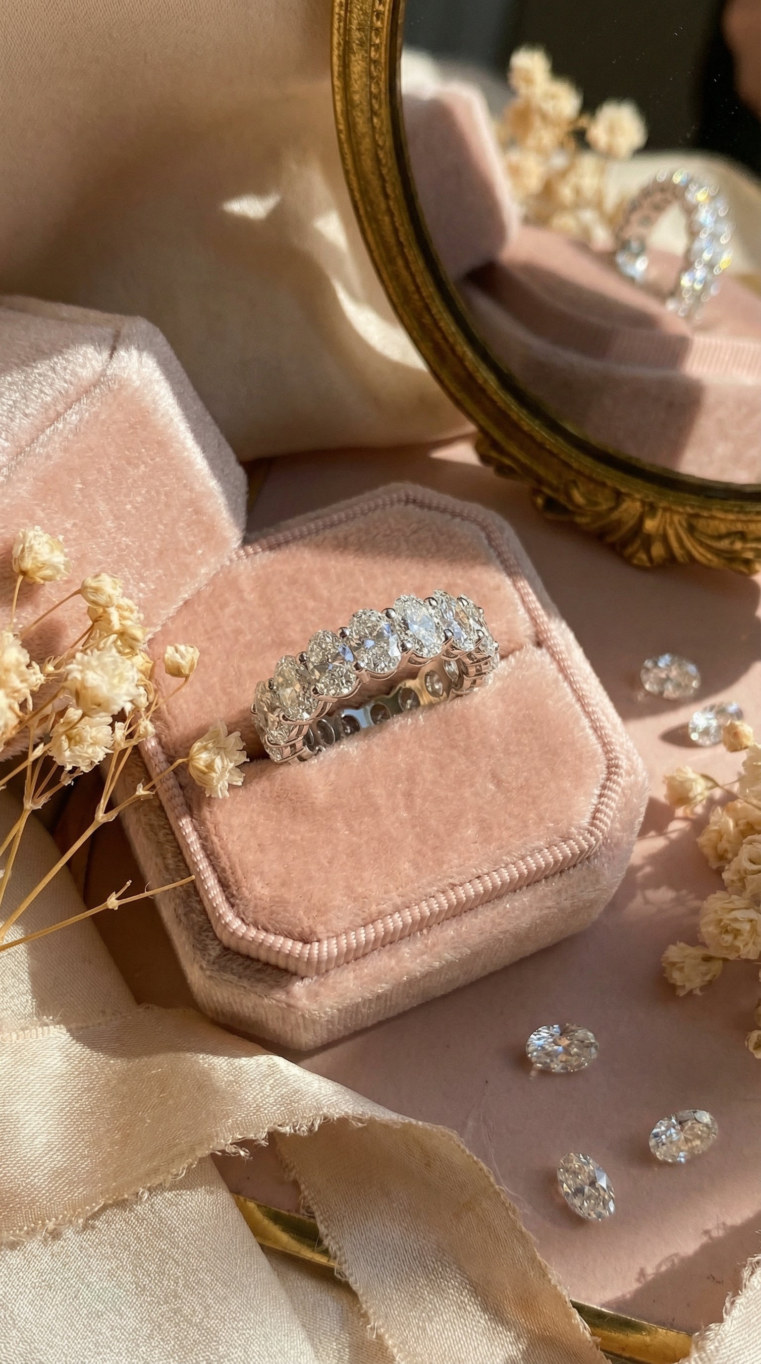 collage of models with different skin tones wearing oval lab grown diamond eternity band demonstrating fit and brilliance across diverse hands