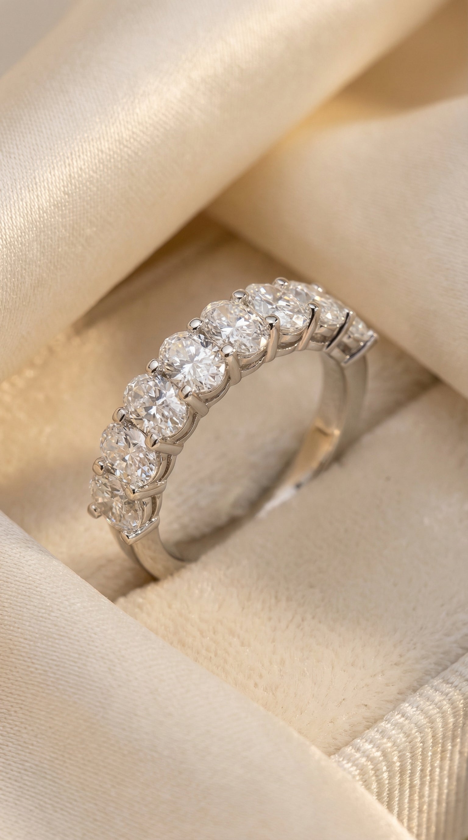 Detailed macro close-up of seven oval lab grown diamonds in shared prong setting revealing diamond brilliance, craftsmanship and smooth comfort fit band