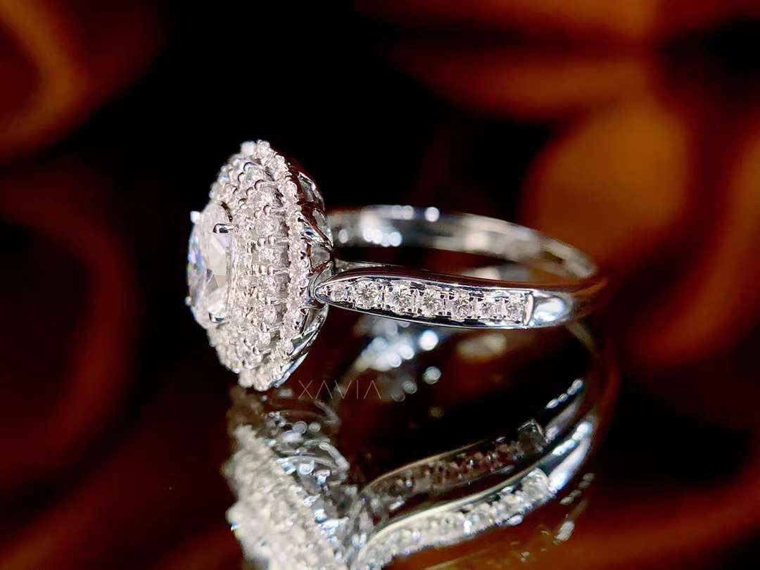 Silver ring with diamond accents on a reflective surface