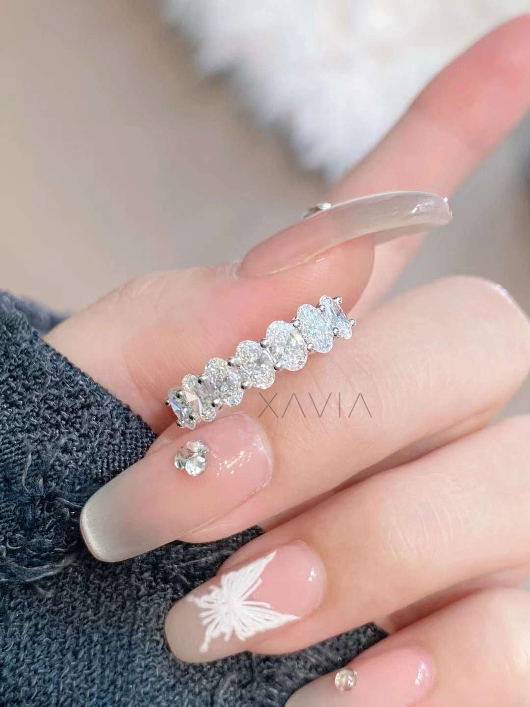 Oval half band worn on hand with neutral nail styling