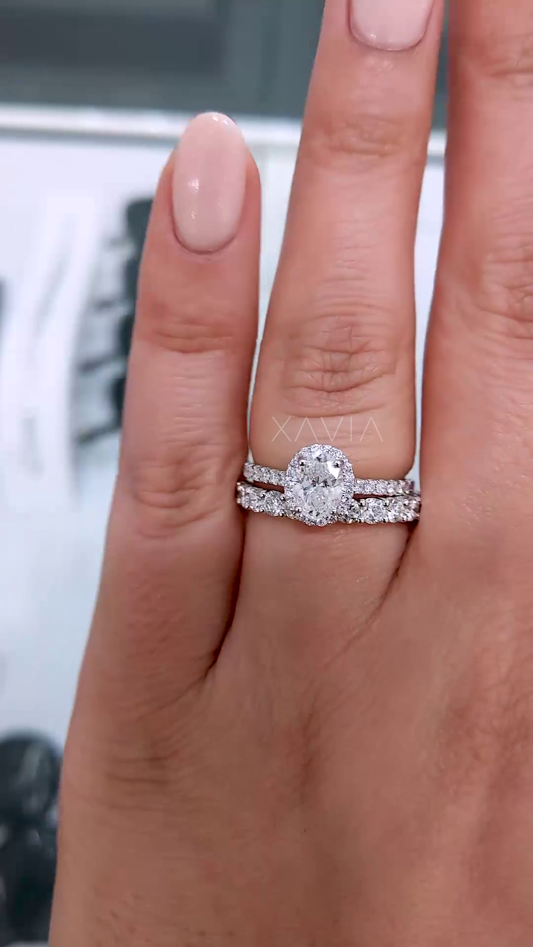 stacked bridal set featuring oval lab diamond halo engagement ring with pavé wedding band showing complete elegant wedding ring combination