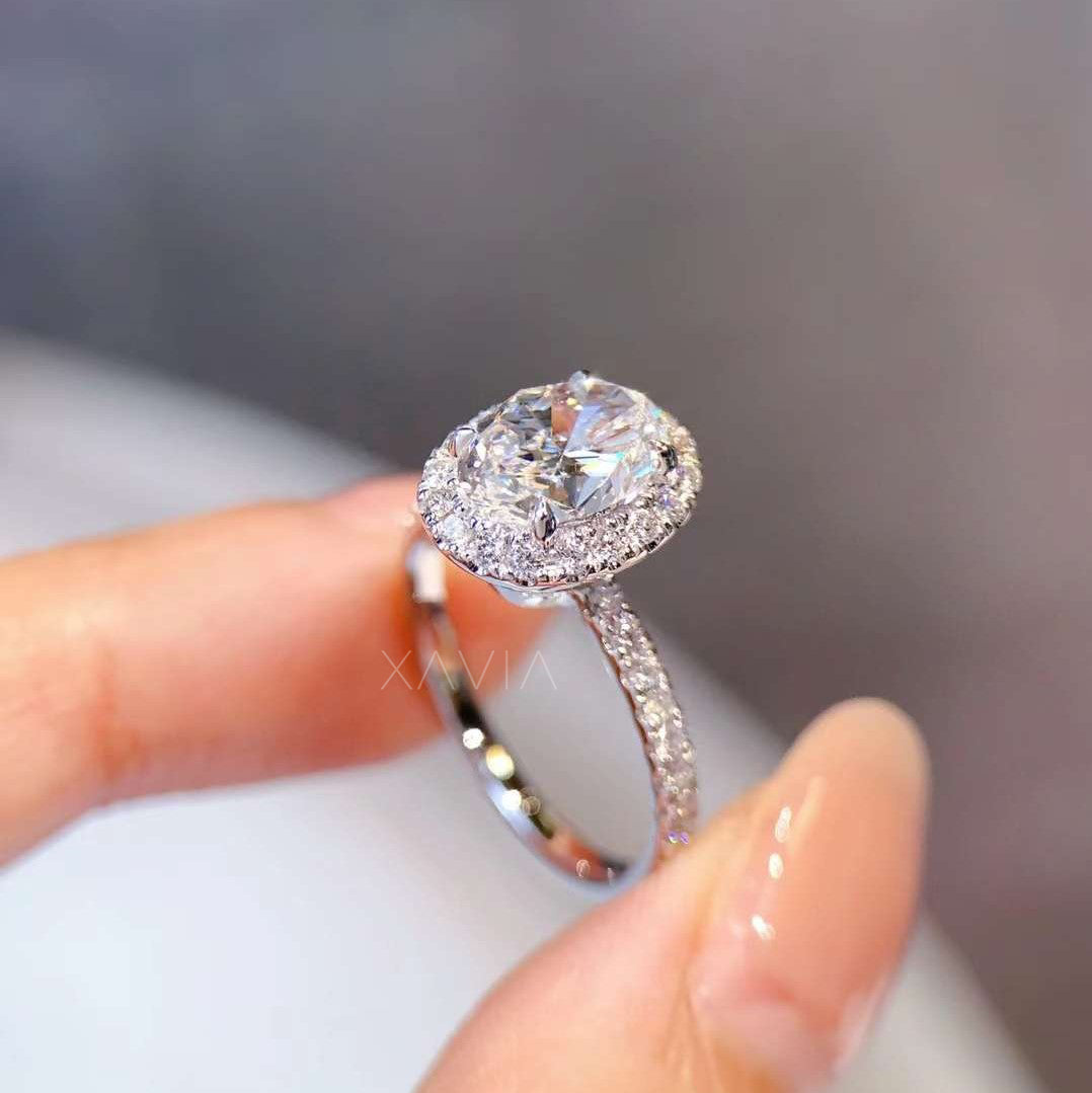 sparkling oval-cut lab diamond ring with pavé band in bright light