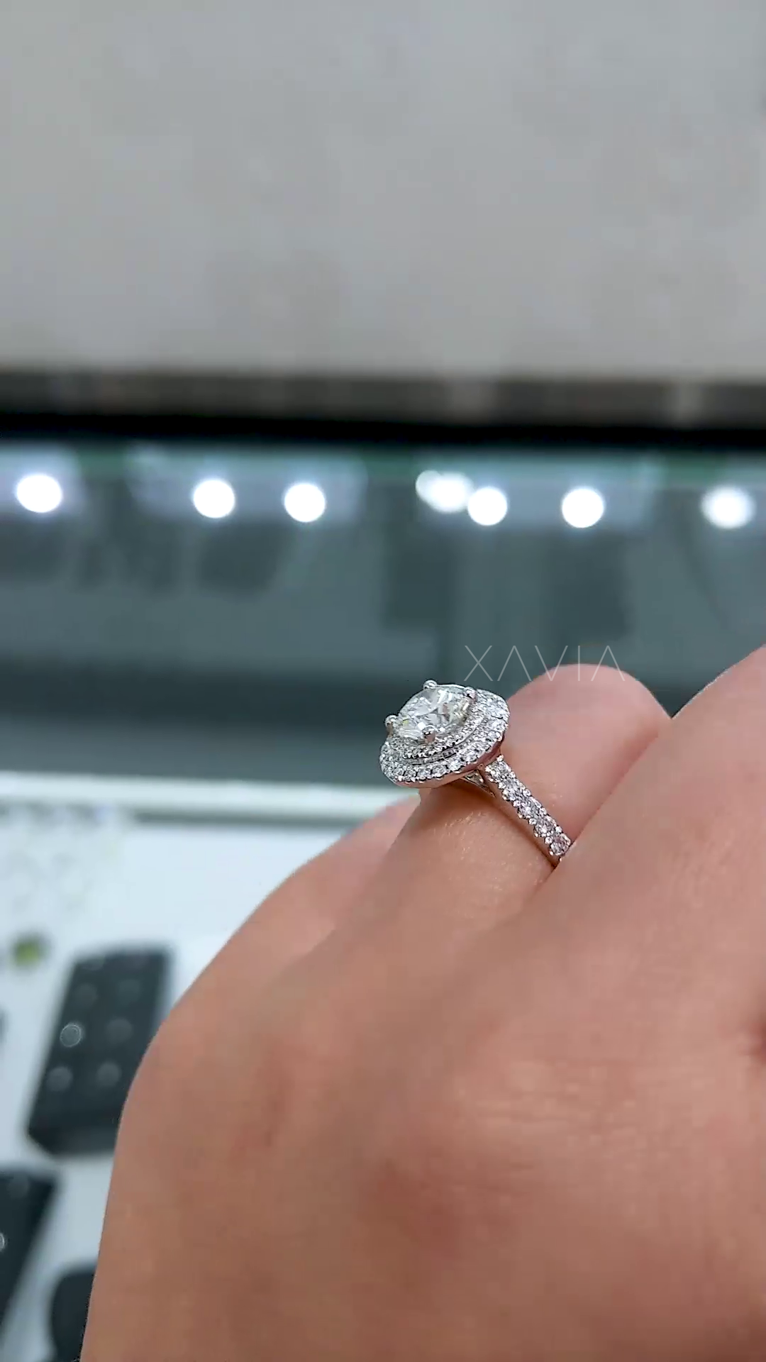 angled perspective of double halo engagement ring with pavé shank emphasizing diamond detailing and refined slim band design