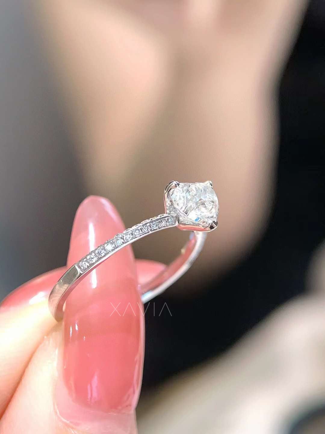 angled close-up of ethical lab-grown heart cut diamond solitaire ring with pavé detailing on slim band