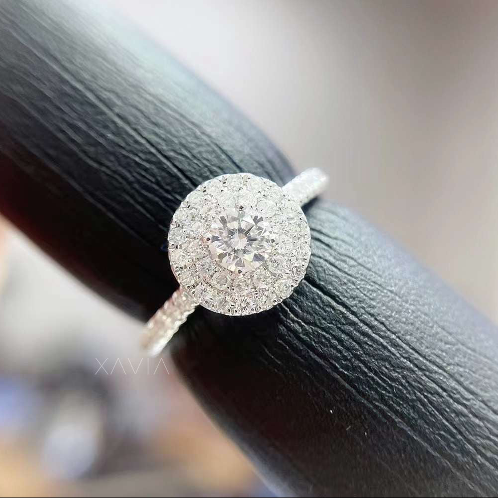 Close-up of round cut lab diamond center with pavé halo detailing and precision hand-set diamonds for maximum brilliance