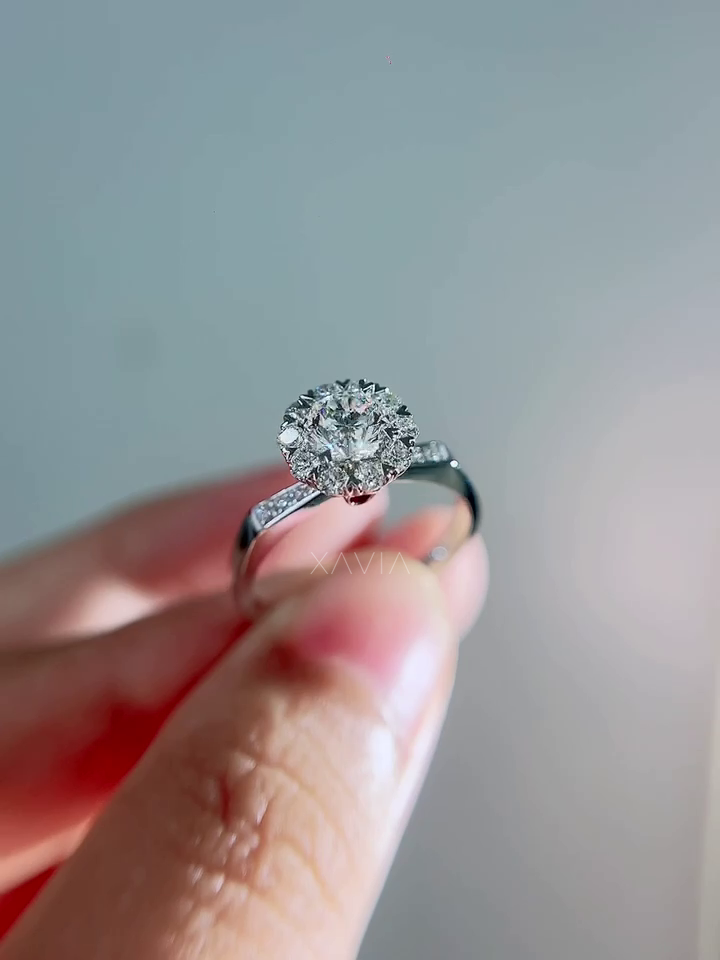 Front angled image of floral halo lab diamond engagement ring highlighting pavé diamond shoulders and polished white gold band