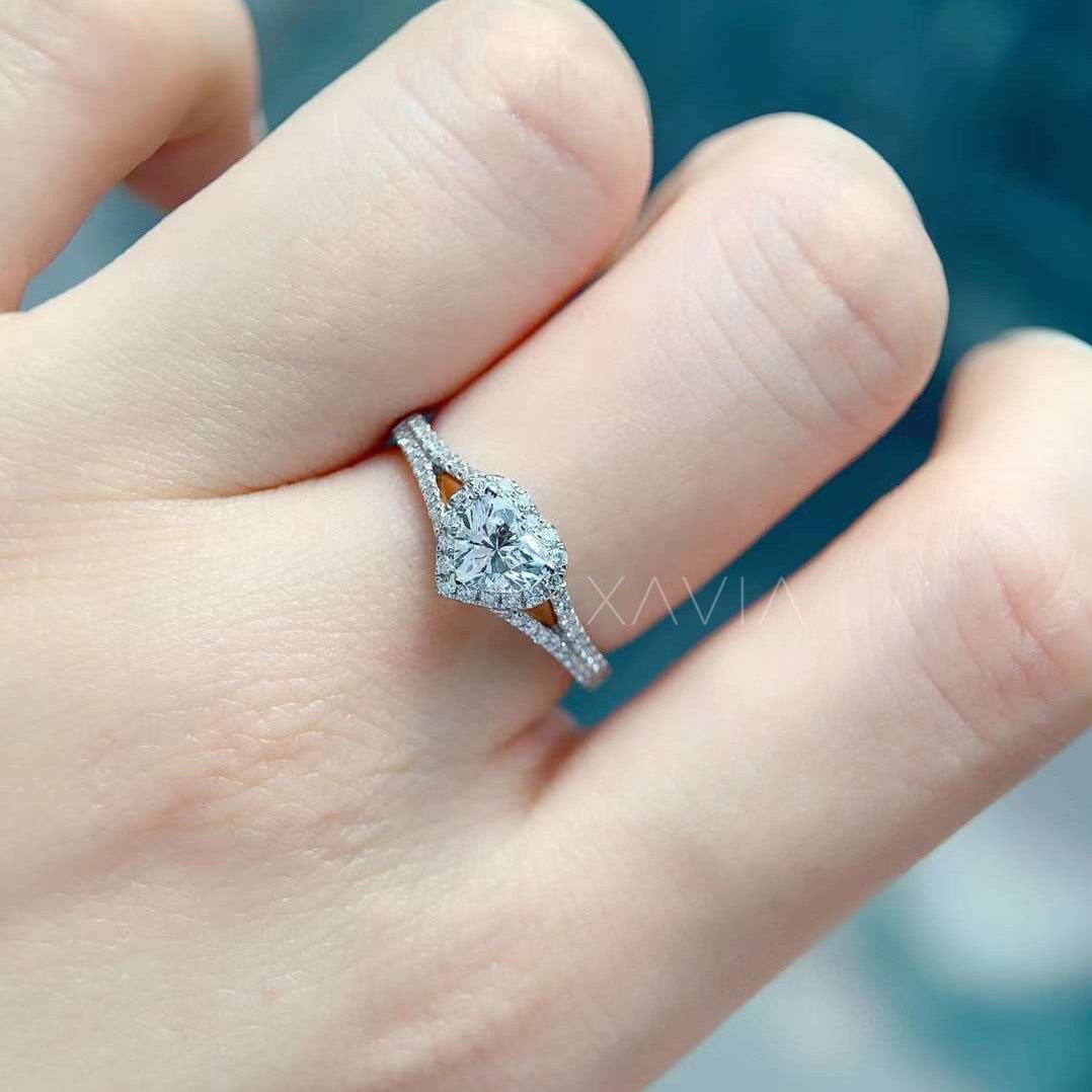 heart cut diamond ring worn on hand with sparkling pavé shank