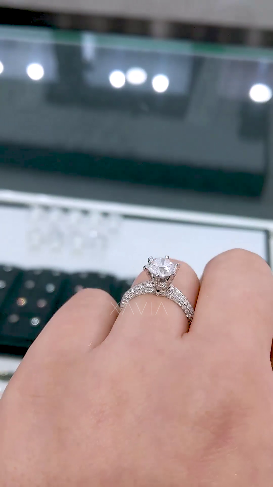 Side profile of round solitaire engagement ring featuring pavé split shank, six-prong setting, and hidden halo sparkle